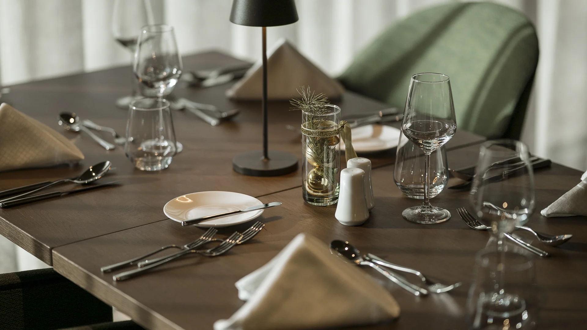 Elegant wooden table set with glasses and cutlery in a restaurant
