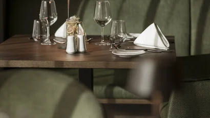 Elegant set table with green chairs and glassware in a restaurant